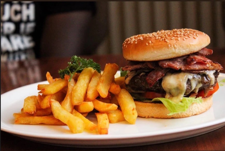 A bacon cheeseburger with fries