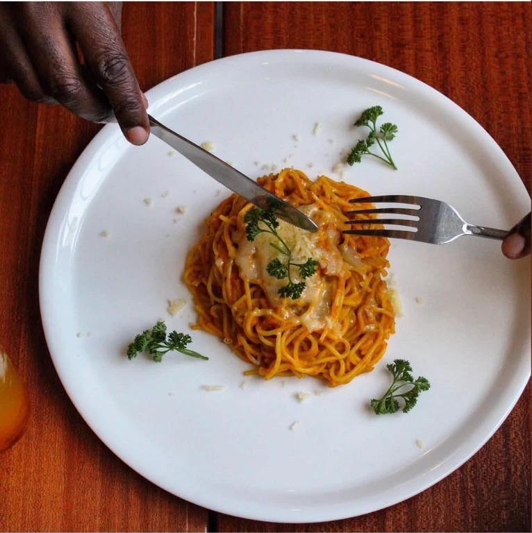 A plate of pasta with parmesan and parsley at the café